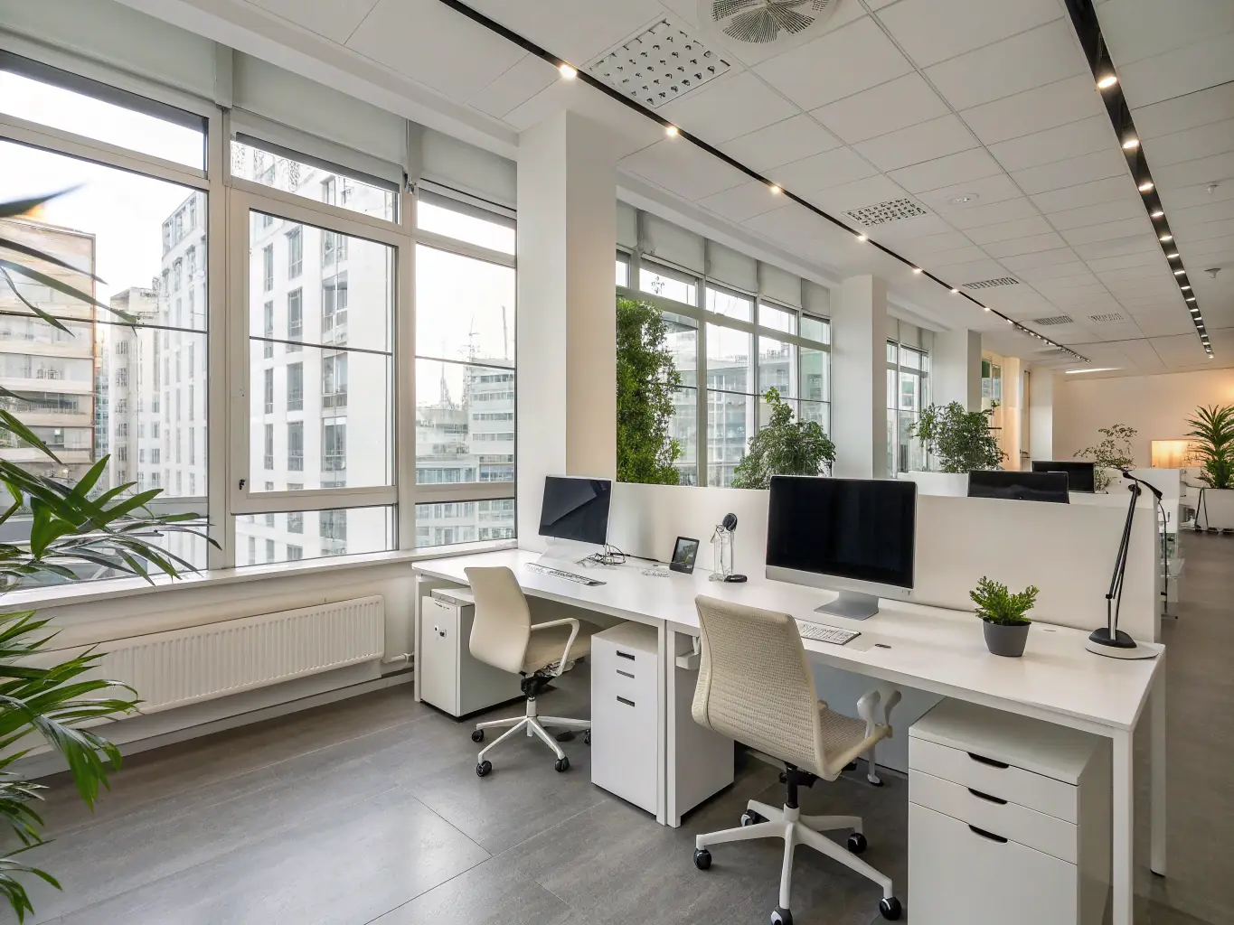 A professionally styled photograph featuring a modern, minimalist desk with clean lines, a spacious work surface, and integrated cable management, set in a bright and airy office space.